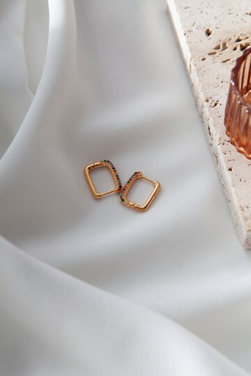 aesthetic-golden-earrings-top-view_23-2149846565
